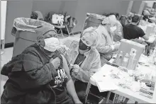  ?? [SETH WENIG/ THE ASSOCIATED PRESS] ?? Mary Jenkins, left, received the COVID-19 vaccine Thursday in Paterson, N.J.