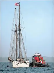  ?? SEAN D. ELLIOT/THE DAY ?? The Thames Towboat Co. tug John Paul tows the schooner Alabama on Monday from its position grounded off Morgan Point in Noank.