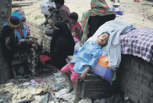  ??  ?? A boy naps under the shade of a tree after an early Sunday fire razed down a Rohingya camp in the Kalindi Kunj area of New Delhi, April 15.