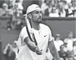  ?? GLYN KIRK/AFP VIA GETTY IMAGES ?? Nick Kyrgios returns a shot to Brandon Nakashima during their round of 16 singles match at Wimbledon on Monday.