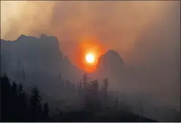  ?? NOAH BERGER THE ASSOCIATED PRESS ?? Smoke from the Caldor fire wafts over a ridgetop near Kirkwood Ski Resort in Eldorado National Forest on Tuesday.