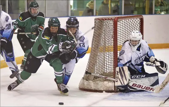  ?? STEVEN MAH/SOUTHWEST BOOSTER ?? Taylor Lind (second from right) tried to knock Saskatoon’s Grace Shirley (centre) off the puck near the crease of goaltender Amaya Giraudier.