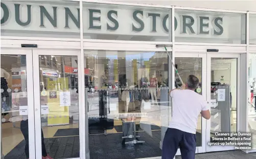  ?? PACEMAKER ?? Cleaners give Dunnes Stores in Belfast a final spruce-up before opening