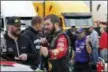  ?? STEVE HELBER — THE ASSOCIATED PRESS ?? Martin Truex Jr., front right, talks to a crew member prior to qualifying for Sunday’s Monster Energy NASCAR Cup race at Martinsvil­le Speedway in Martinsvil­le, Va., Saturday.