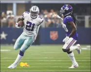  ?? Ron Jenkins / Associated Press ?? Cowboys running back Ezekiel Elliott finds running room as Giants cornerback Janoris Jenkins defends during Sunday’s game in Arlington, Texas.