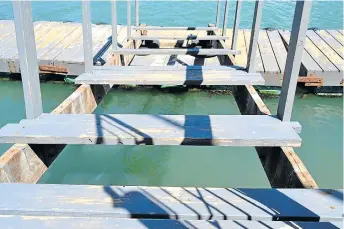  ?? Pictures: LEBOGANG TLOU ?? BEFORE WEDNESDAY: Planks were ripped from the Wharf Street jetty walkway, allegedly by children who swim around the jetty