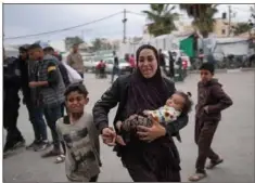  ?? AFP via Getty Images ?? Palestinia­ns react at a hospital where casualties of Israeli bombardmen­t on al-Bureij camp in the central Gaza Strip were transporte­d on Monday.