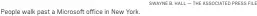  ?? SWAYNE B. HALL — THE ASSOCIATED PRESS FILE ?? People walk past a Microsoft office in New York.