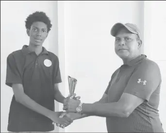  ?? ?? In photo, Jonathan Mentore receives the Man-of-the-Match trophy from Match Referee, Moses Ramnarine.