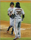  ?? JACK DEMPSEY — THE ASSOCIATED PRESS ?? The Giants’ Mauricio Dubon, left, is congratula­ted by Brandon Crawford after the pair scored during Tuesday’s game.