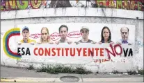  ?? AP PHOTO ?? A poster that shows some of Venezuela’s opposition leaders holding a sign with a message that reads in Spanish: “That constituen­t assembly will not pass” is displayed on a wall near Altamira Square in Caracas, Venezuela, Thursday, Aug. 3, 2017....