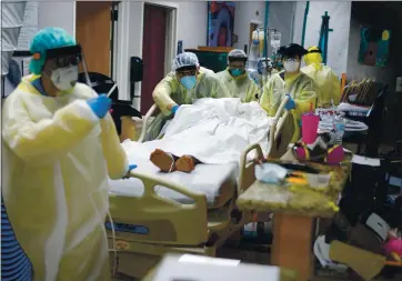  ?? MARK FELIX — GETTY IMAGES ?? Health care workers move a patient in the COVID-19 unit at United Memorial Medical Center in Houston, Texas, last week.