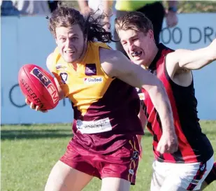  ??  ?? Jack Baker, in his first game back for Drouin after injury, has a break on his Maffra chaser in the senior game on Saturday but hobbled from the ground in the last quarter after another leg injury.