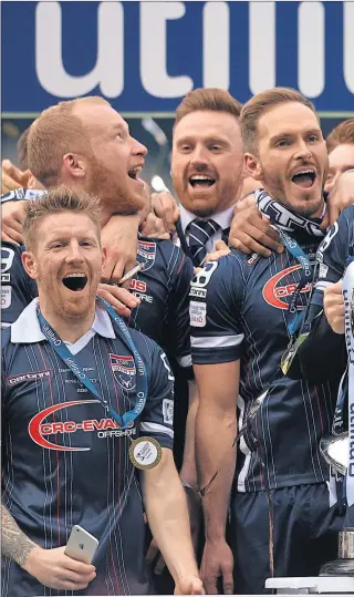  ??  ?? HAMPDEN HEROES: Ross County captain Andrew Davies lifts the League Cup trophy, and the e victory will prompt tears of joy in Dingwall, predicted Alex Schalk who scored the winner for the Staggies