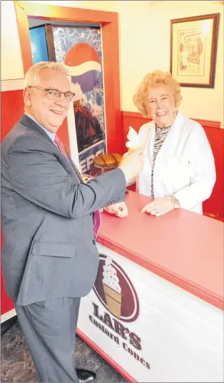  ?? KENN OLIVER/THE TELEGRAM ?? Winnie Crocker serves a custard cone to St. John’s Mayor Danny Breen Thursday at the Newfoundla­nd Embassy on Gower Street, a little wooden building that was once home for Lar’s Fruit Market. Crocker and her late husband, Lar, owned and operated the mom and pop shop for nearly five decades. When Chris Andrews and Tom Nemec decided to establish a pub and restaurant at the site, they opted to pay homage to the Crockers’ legacy by creating a little takeout counter called Lar’s Custard Cones.