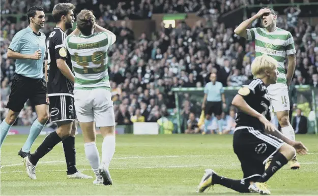  ??  ?? 0 Tom Rogic, right, and James Forrest show their frustratio­n after winger Forrest came close to breaking the deadlock against Rosenborg at Celtic Park last night.