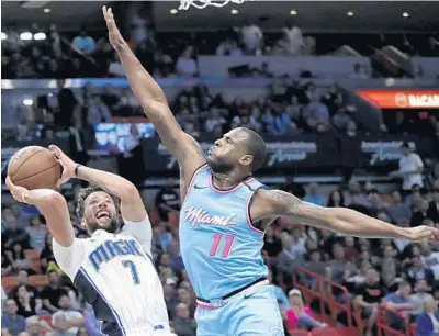  ?? LYNNE SLADKY/AP ?? Orlando Magic guard Michael Carter-Williams attempts to shoot as Heat guard Dion Waiters defends during a January game.