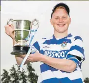  ??  ?? Newtonmore captain Cameron McNiven with the Sutherland Cup.