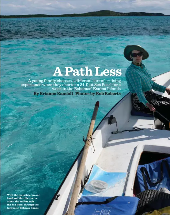  ??  ?? With the mainsheet in one hand and the tiller in the other, the author sails the Sea Pearl through the turquoise Bahama Banks.