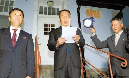  ?? AP-Yonhap ?? North Korea’s top nuclear negotiator Kim Myong-gil, center, reads a statement outside the North Korean embassy in Stockholm, Sweden, Sunday (KST) after working-level nuclear talks with his U.S. counterpar­t, Stephen Biegun.