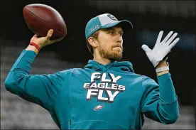  ?? JONATHAN BACHMAN / GETTY IMAGES ?? Nick Foles of the Philadelph­ia Eagles warms up before the NFC Divisional Playoff against the New Orleans Saints at the Mercedes Benz Superdome on Sunday in New Orleans, Louisiana.