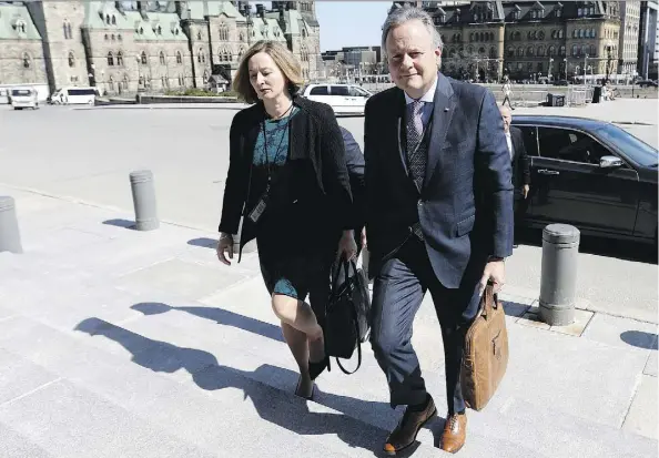  ?? THE CANADIAN PRESS/JUSTIN TANG ?? Governor of the Bank of Canada, Stephen Poloz, and Senior Deputy Governor Carolyn Wilkins arrive on Parliament Hill in April. If increased protection­ist measures result in higher prices, the central bank will be duty bound to stop the spread of inflation.