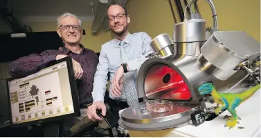  ?? PETER POWER / THE CANADIAN PRESS ?? Professors Maikel Rheinstadt­er, right, and Ralph Pudritz pose with the planet simulator at the origins of life lab at McMaster University in Hamilton, Ont. The researcher­s are using the lab to simulate and test Darwin’s “warm little ponds” theory of how life began on Earth.