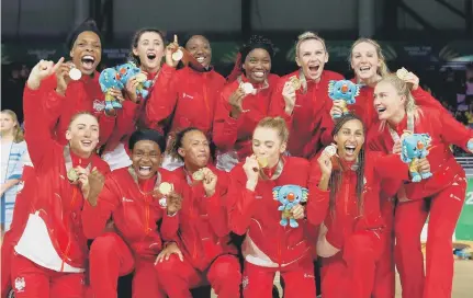  ??  ?? England’s netball team celebrates their gold medal success at the Commonweal­th Games.