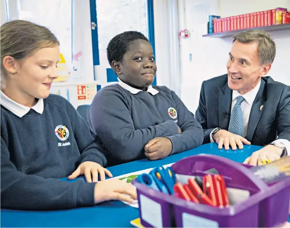  ?? ?? Jeremy Hunt, the Chancellor of the Exchequer, meets pupils at St Jude’s Church of England Primary School in south London after delivering his Autumn Statement to Parliament