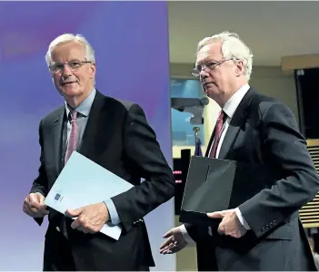  ?? EMMANUEL DUNAND/GETTY IMAGES ?? British Secretary of State for Exiting the European Union David Davis, right, and European Commission member in charge of Brexit negotiatio­ns with Britain, Michel Barnier, leave after addressing a press conference at the end of the first day of Brexit...