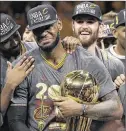  ?? MARCIO JOSE SANCHEZ / AP ?? Cleveland Cavaliers forward LeBron James (center) celebrates with teammates, including Kevin Love (right), after winning Game 7 of the NBA Finals.