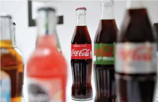  ?? REUTERS ?? BOTTLES OF COCA-COLA are pictured during a news conference in Paris, France, April 20.