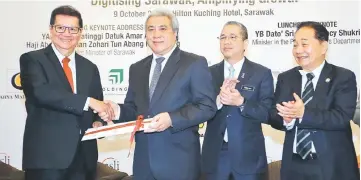  ??  ?? Yeoh (left) presents a memento to Awang Tengah. Seen from right are Wong and Fadillah. — Photo by Muhammad Rais Sanusi