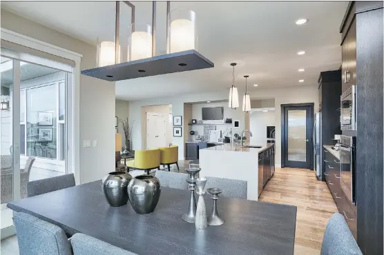  ?? PHOTOS: ALBI HOMES ?? The kitchen of the Manhattan 4 in Westmere features a quartz-topped island, stainless steel Whirlpool appliances and hardwood flooring.