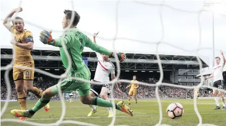  ?? PICTURE: REUTERS ?? TWO OF THREE: Tottenham’s Harry Kane scores his clubs second goal in their 3-0 rout of Fulham in fifth round FA Cup action at Craven Cottage yesterday. Kane scored a hat-trick for Spurs.