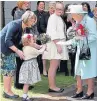  ??  ?? Agatha presenting a posy to the Queen at the Scottish Parliament in 2016.