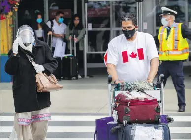  ??  ?? Narender Cheema shuttles luggage on Wednesday for his mother, Mahinder Kaur Cheema, 80, who had been stuck in India since the start of the coronaviru­s pandemic.