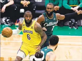  ?? Michael Dwyer Associated Press ?? LeBRON JAMES had a big game versus Jaylen Brown and Boston, with 41 points, nine rebounds and eight assists, but didn’t get a key call at the end of regulation.