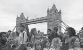  ?? DAN KITWOOD, GETTY IMAGES ?? Members of the public take part in a vigil for the victims of the London Bridge terror attacks, in Potters Fields Park Monday in London, England. Seven people were killed.