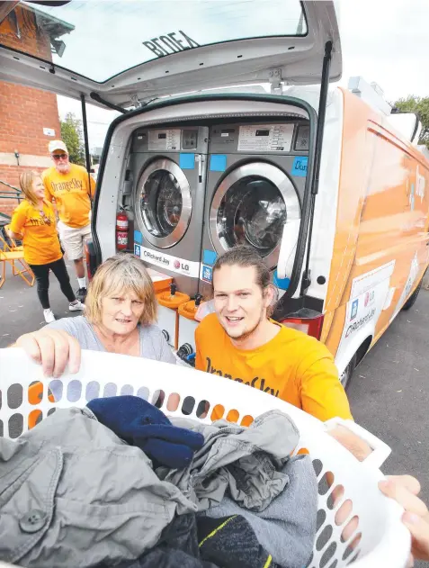  ?? Picture: GLENN FERGUSON ?? Orange Sky co-founder Lucas Patchett, right, with Marilyn Heywood, who uses the service for her washing.