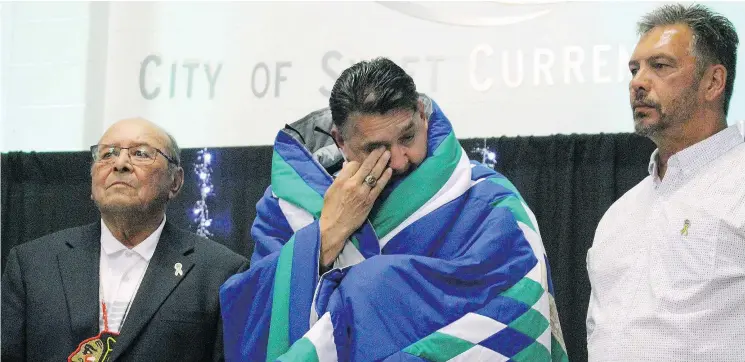  ?? SHERI TRAPP/SASKATCHEW­AN HOCKEY ASSOCIATIO­N ?? Ron Delorme, centre, is honoured by Fred Sasakamoos­e, left, at a star blanket ceremony at the Beardy’s First Nation, his community.