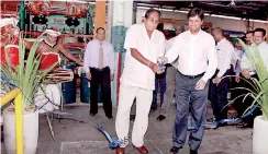  ??  ?? CEAT Kelani Internatio­nal Tyres Chairman Chanaka de Silva (left) and CEAT India Managing Director Anant Goenka opening the new motorcycle tyre plant