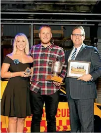  ??  ?? Regional Lifeguard of the Year was Kyle Taylor (centre) from the Ruakaka Surf Lifesaving Club with award presenters Claire Wright and Chris Brearley.