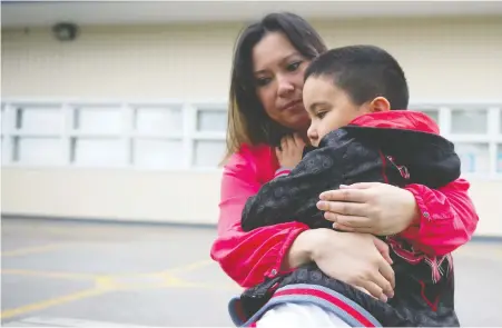  ?? MIKE BELL ?? Richmond’s Kaye Banez hugs her son Lazarus, a student entering Grade 3. Banez says her son, who has autism, won’t be able to adhere to COVID-19 safety protocols, putting himself and others in danger, but school officials say they can’t provide an option for Lazarus to learn from home.
