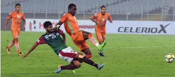  ??  ?? Mohun Bagan’s Shilton D’Silva ( second from left) in action against Neroca FC in their I- League match at Salt Lake Stadium in Kolkata on Tuesday.