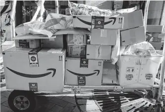  ?? Associated Press file photos ?? To help with peak holiday demand, Amazon, which operates its own fleet of delivery vehicles, said it’s again hiring 150,000 employees for full-time, part-time and seasonal roles in the U.S.