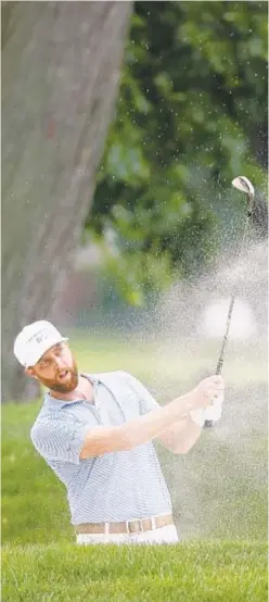  ?? GETTY ?? Chris Kirk blasts out of a bunker on the 17th hole during the second round of the Rocket Mortgage Classic on Friday.