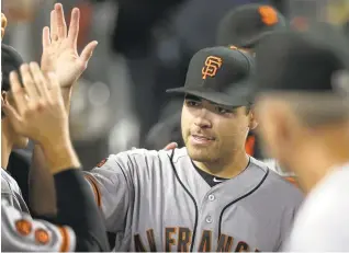  ?? STEPHEN DUNN/GETTY IMAGES ?? The Giants’ Matt Moore is congratula­ted by teammates after allowing one hit in 8 2 ⁄ innings. 3