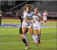  ?? AUSTIN HERTZOG - DIGITAL FIRST MEDIA ?? Spring-Ford’s KK O’Donnell goes airborne to win a header along the sideline.