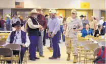  ??  ?? Ranchers and others begin to fill a school auditorium in Animas on Thursday to discuss border security. Area ranchers have been angry about the reported kidnapping of a ranch hand in December.